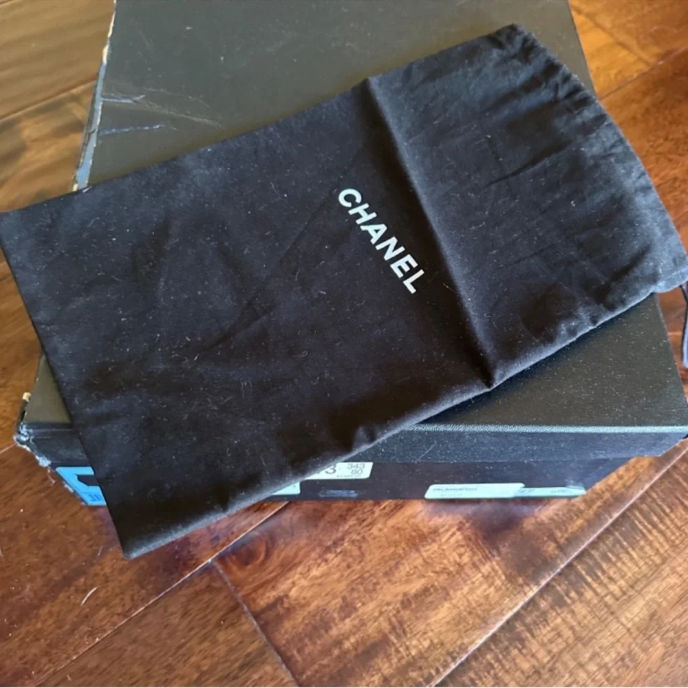 CHANEL Black Leather Wedge Boots with Gold Accent